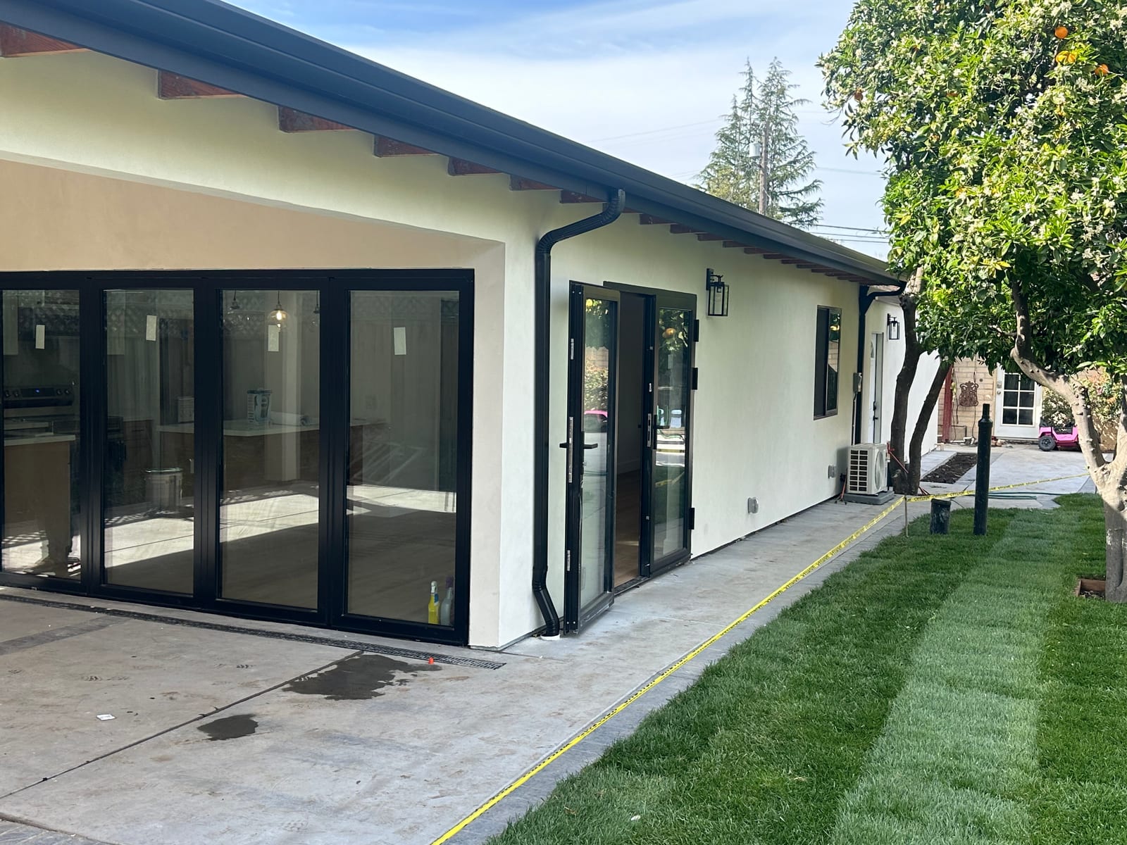 Finished black gutters and downspout on a modern home exterior