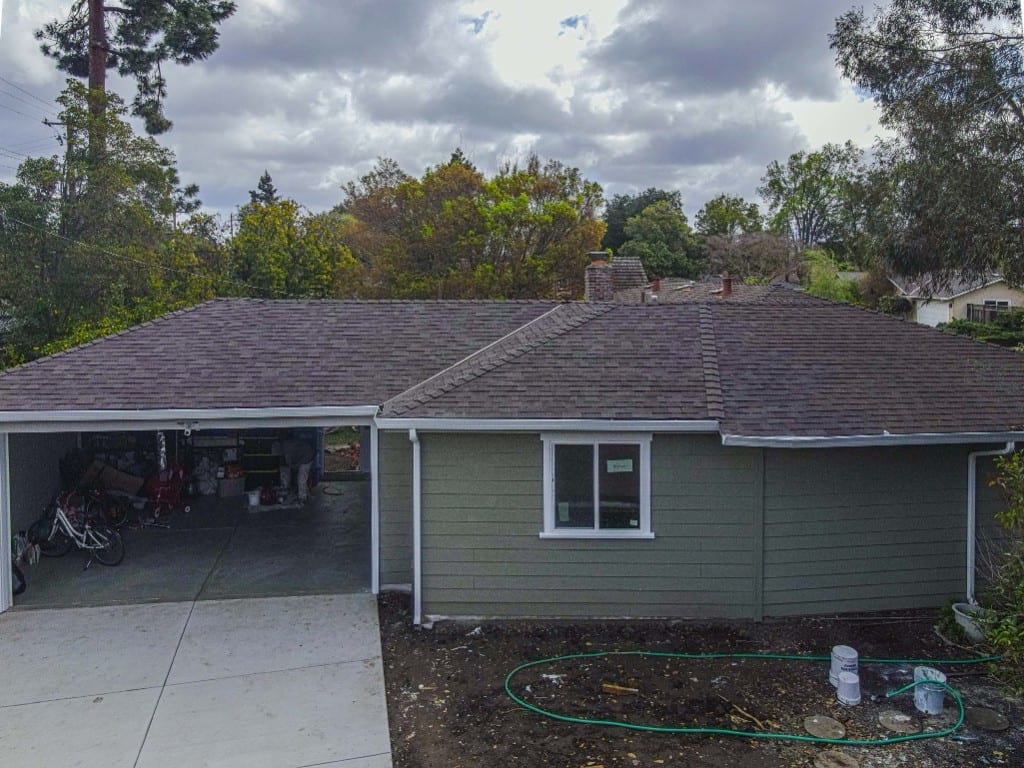 Finished Grace Roofing reroof with asphalt shingles and white gutters