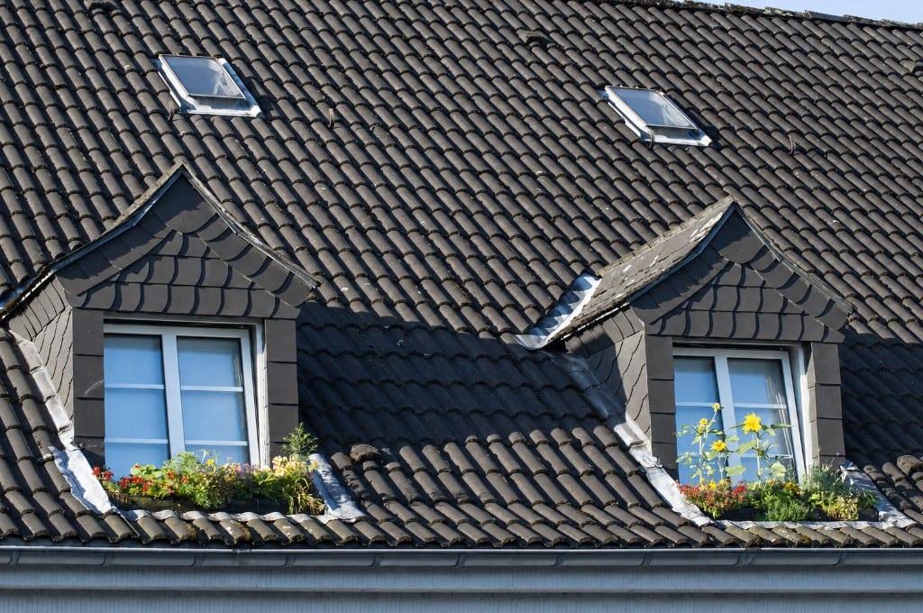 Dark pantile roof with dormers, skylights, and flower boxes
