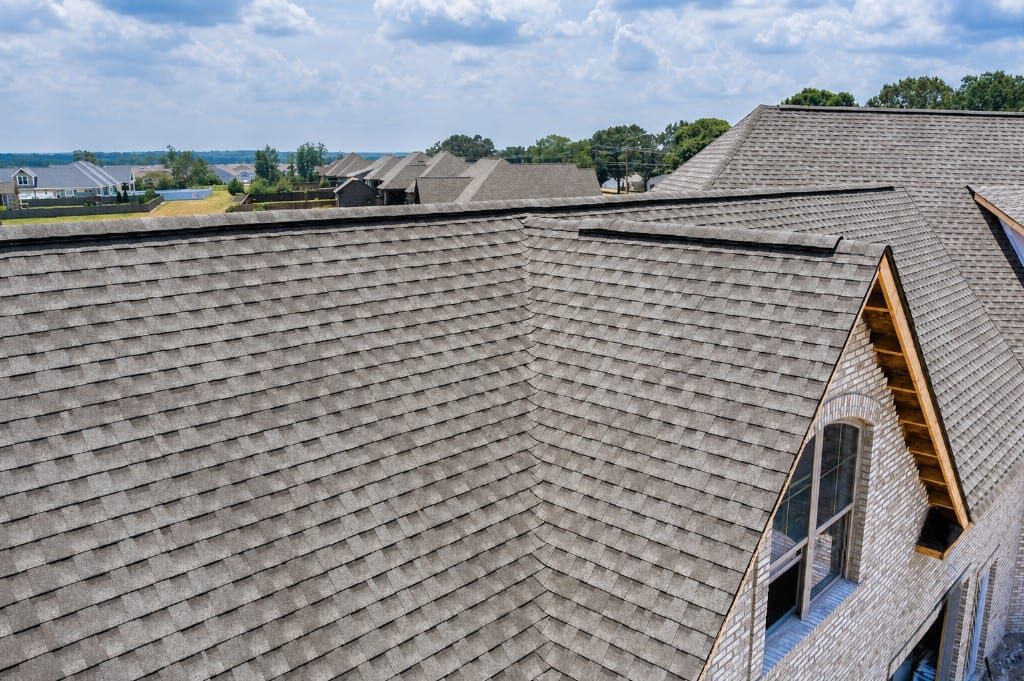 Complex residential roof with architectural shingles and ridge vent
